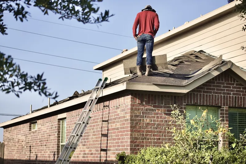 Professional roofer working on a residential roof in Town Creek